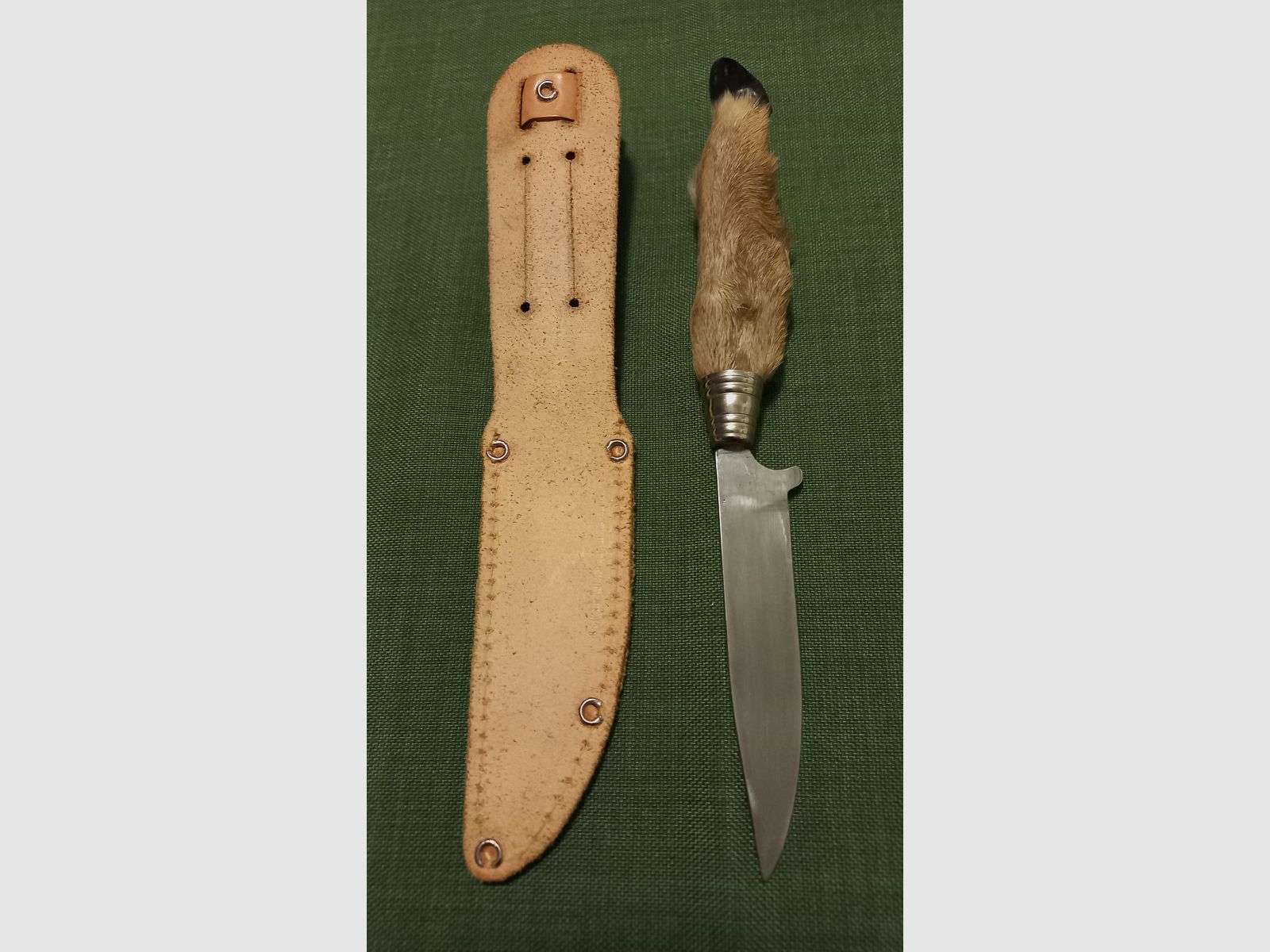 Traditional hunting knife with deer foot handle