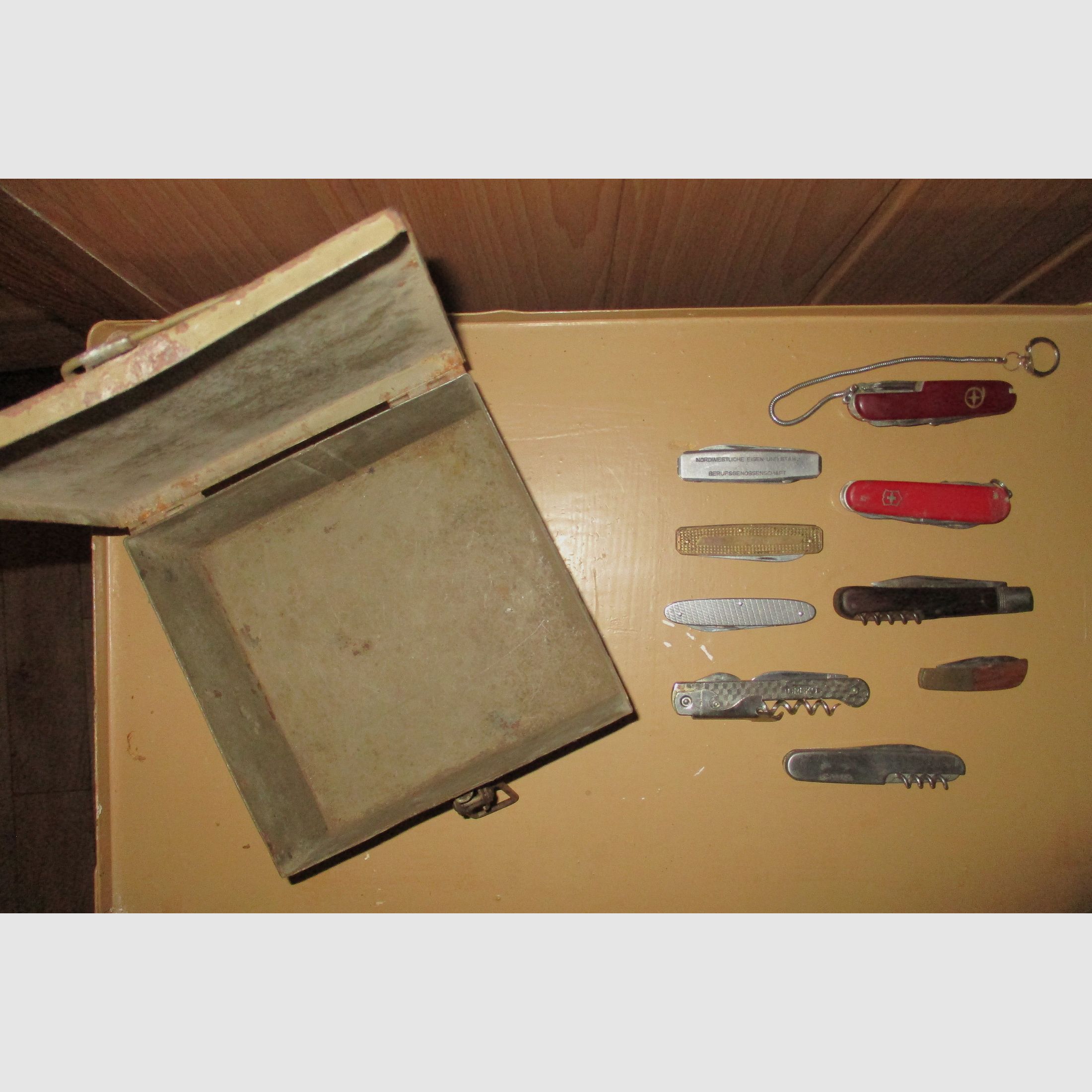 Swiss army knife, among other things, old metal ammunition box, medal on chain, among other things, military