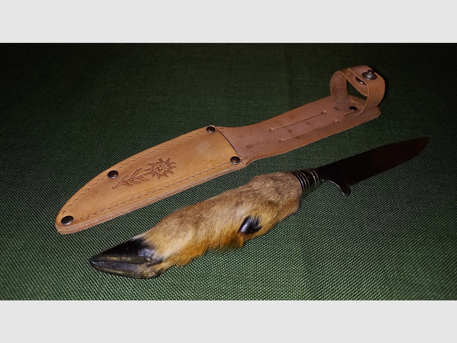 Traditional hunting knife with deer foot handle