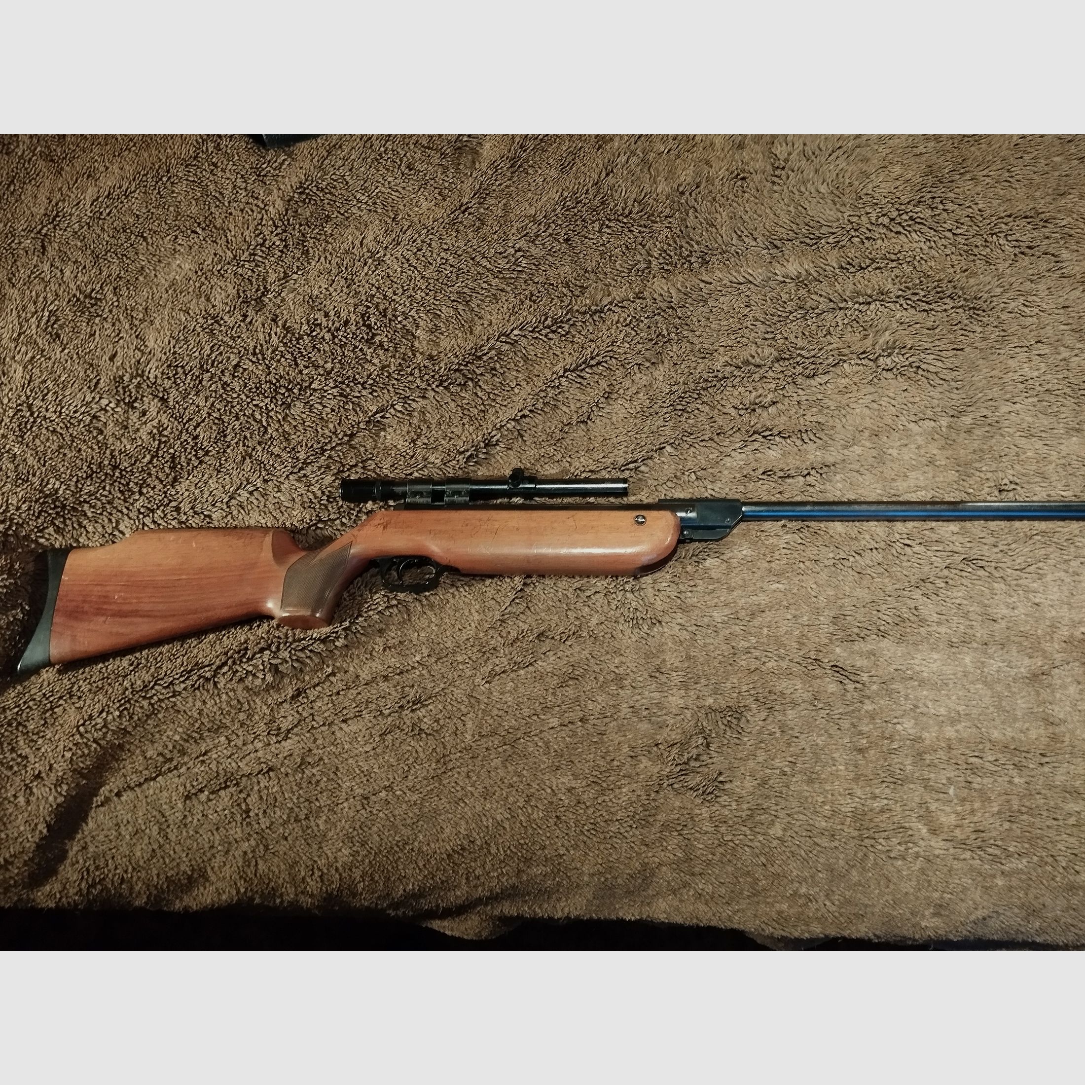 very well-preserved air rifle cal 4.5 mm with solid wooden stock and scope