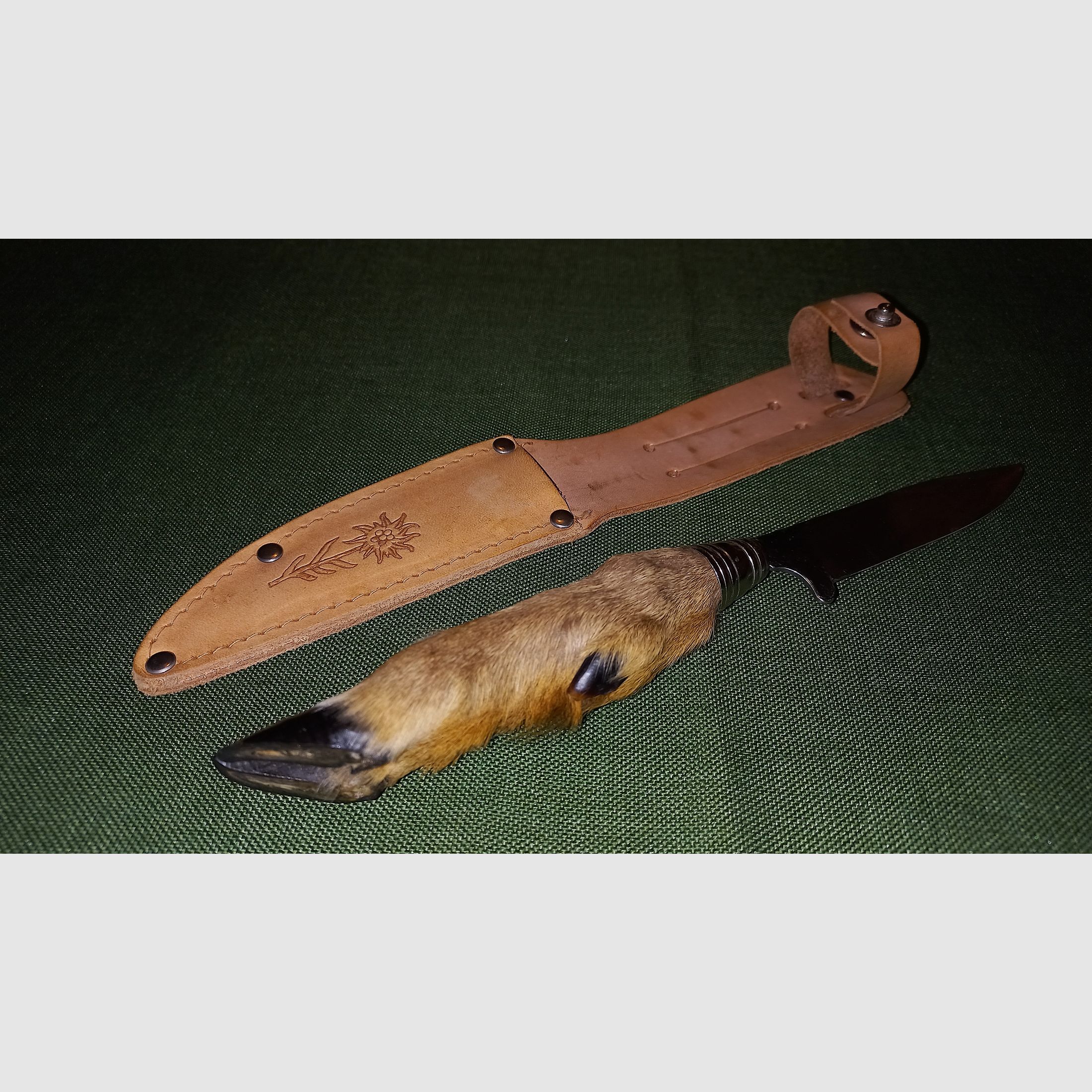 Traditional hunting knife with deer foot handle