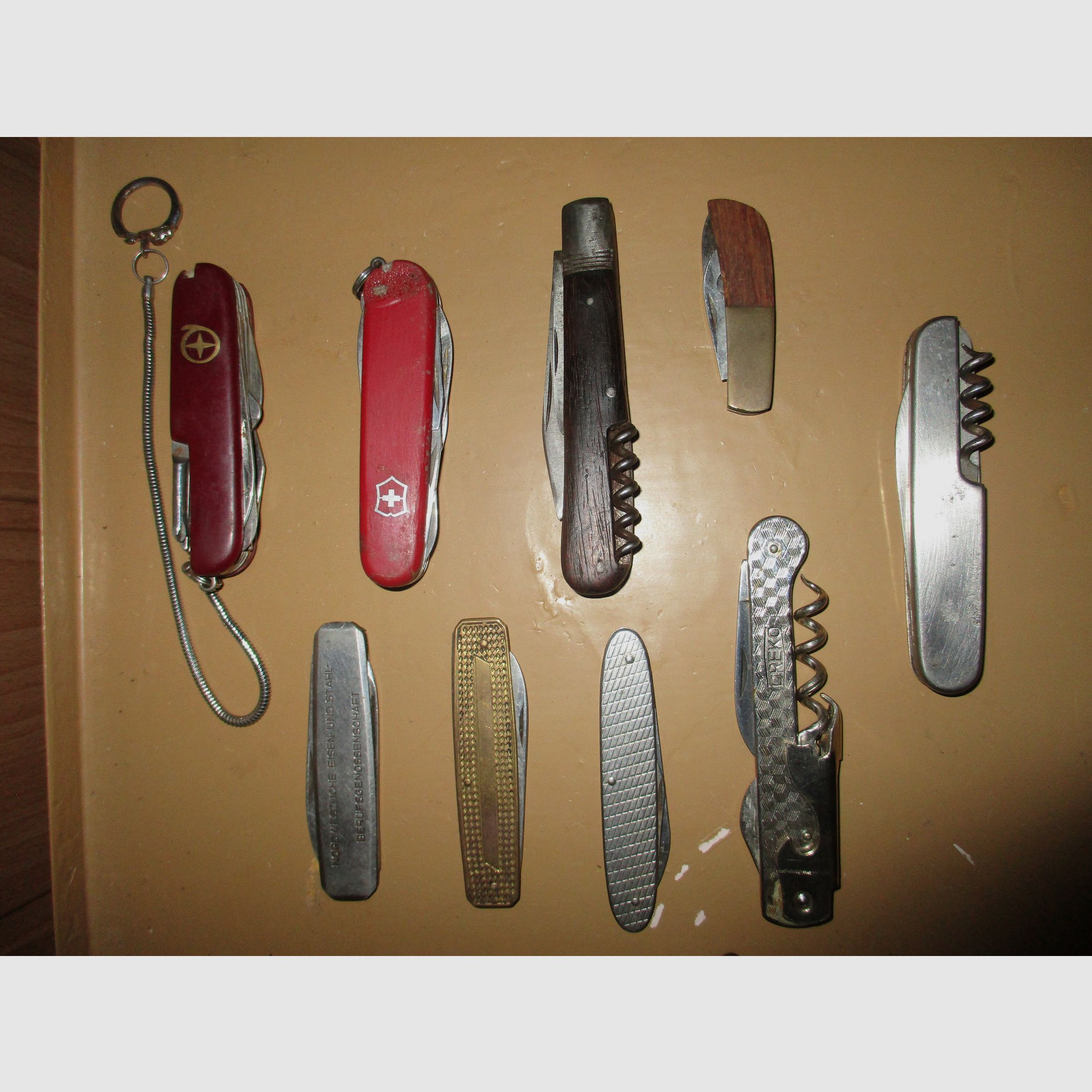Swiss army knife, among other things, old metal ammunition box, medal on chain, among other things, military