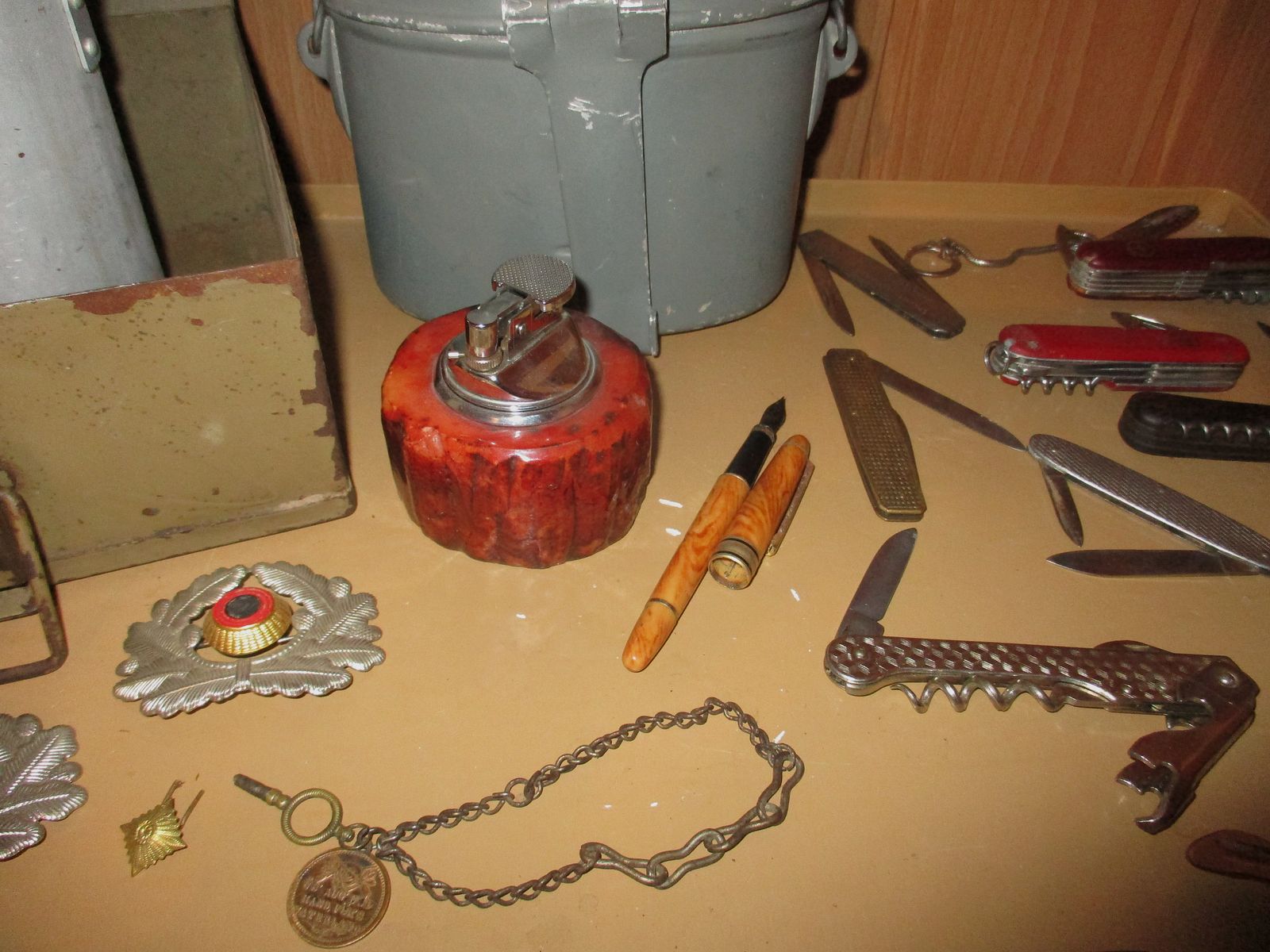 Swiss army knife, among other things, old metal ammunition box, medal on chain, among other things, military