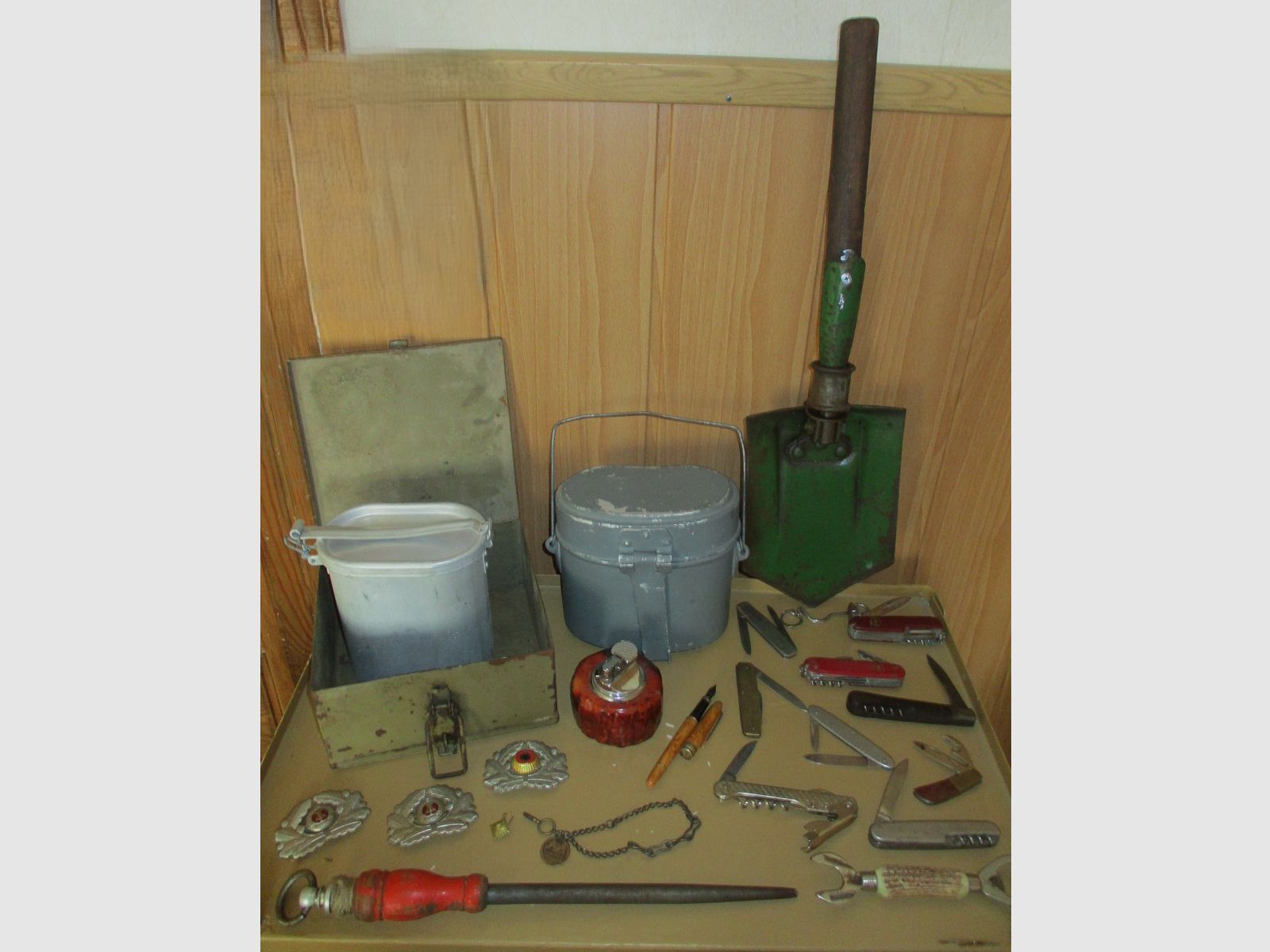 Swiss army knife, among other things, old metal ammunition box, medal on chain, among other things, military