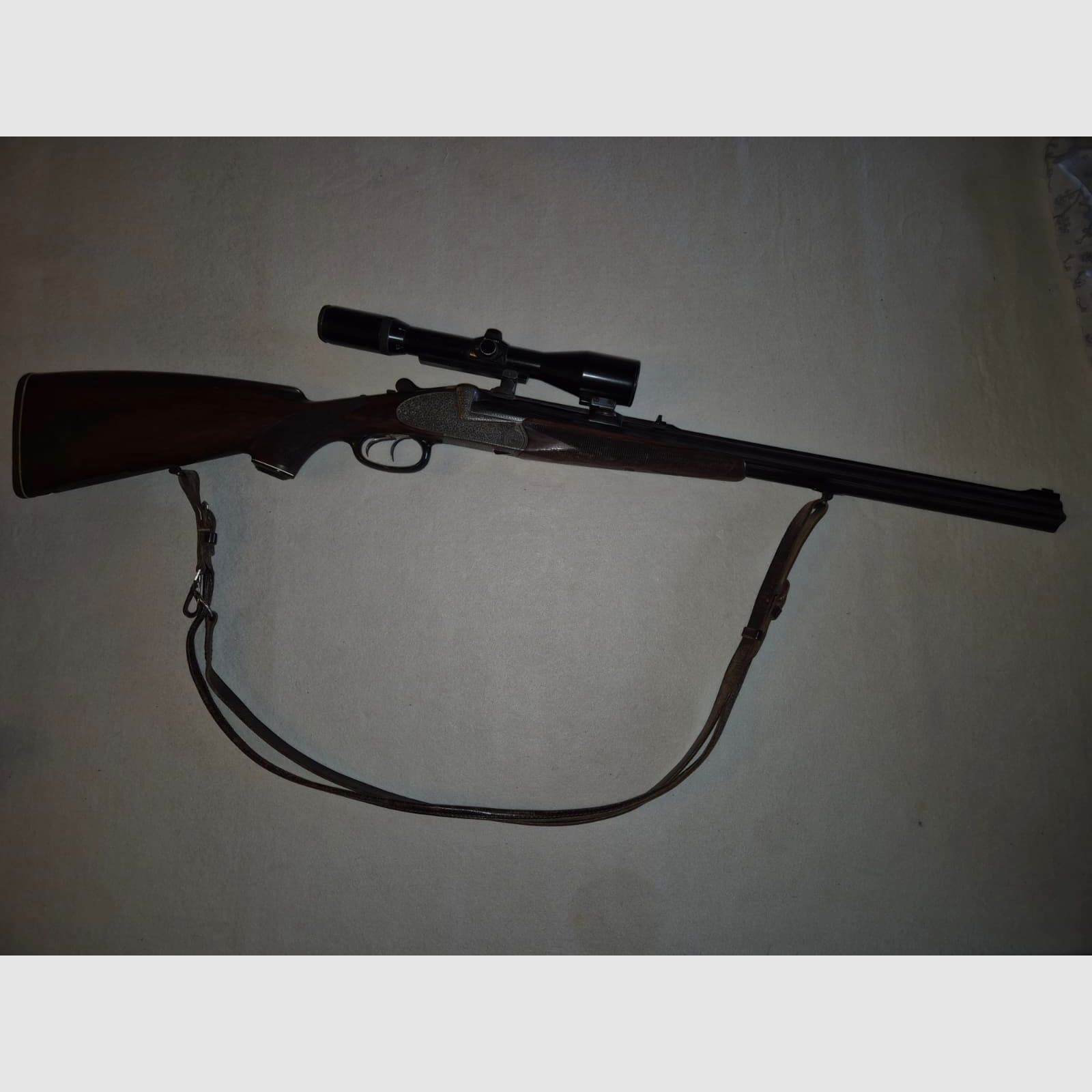 combination gun with two rifle barrels and one shotgun barrel