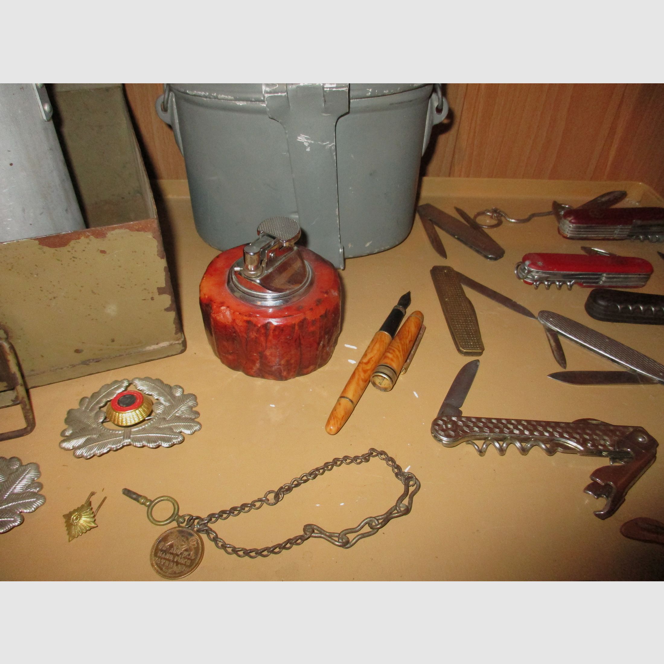 Swiss army knife, among other things, old metal ammunition box, medal on chain, among other things, military