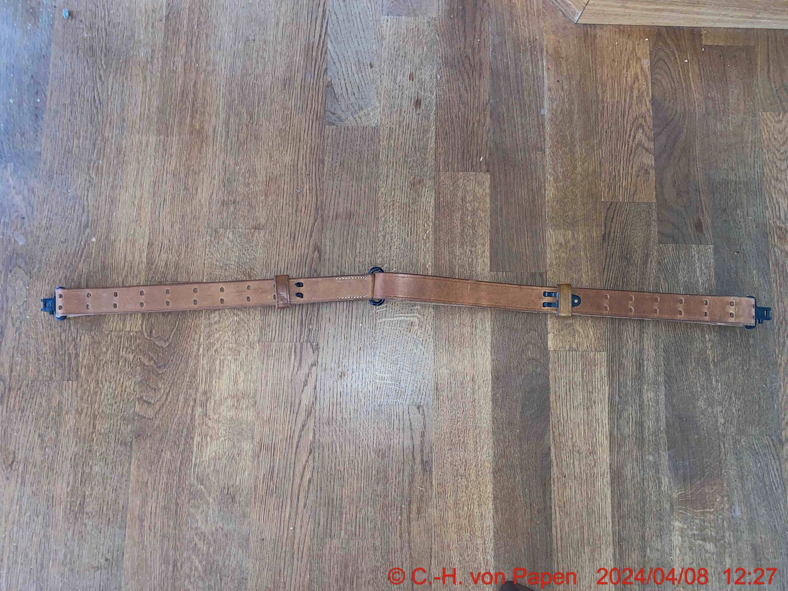 Rifle sling with strap buckle