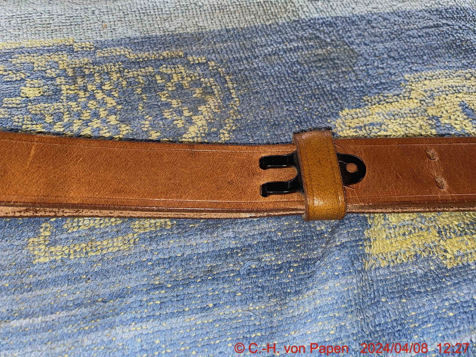 Rifle sling with strap buckle