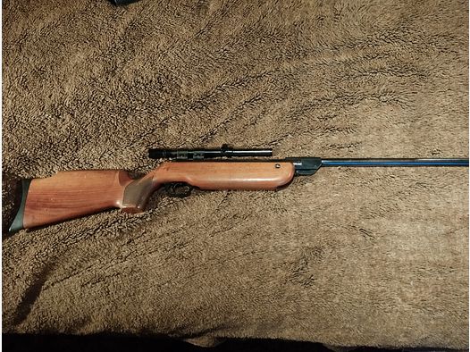 very well-preserved air rifle cal 4.5 mm with solid wooden stock and scope