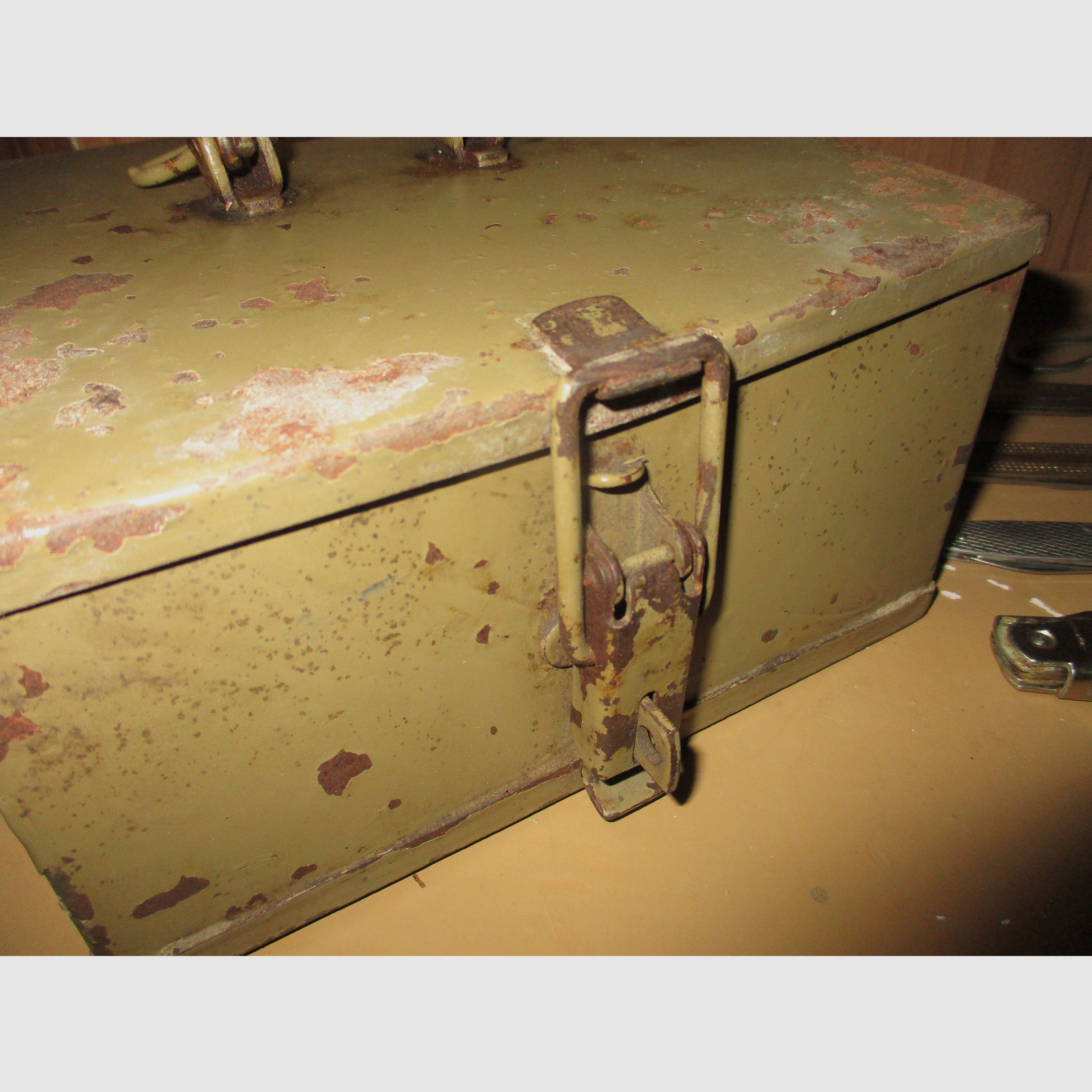 Swiss army knife, among other things, old metal ammunition box, medal on chain, among other things, military