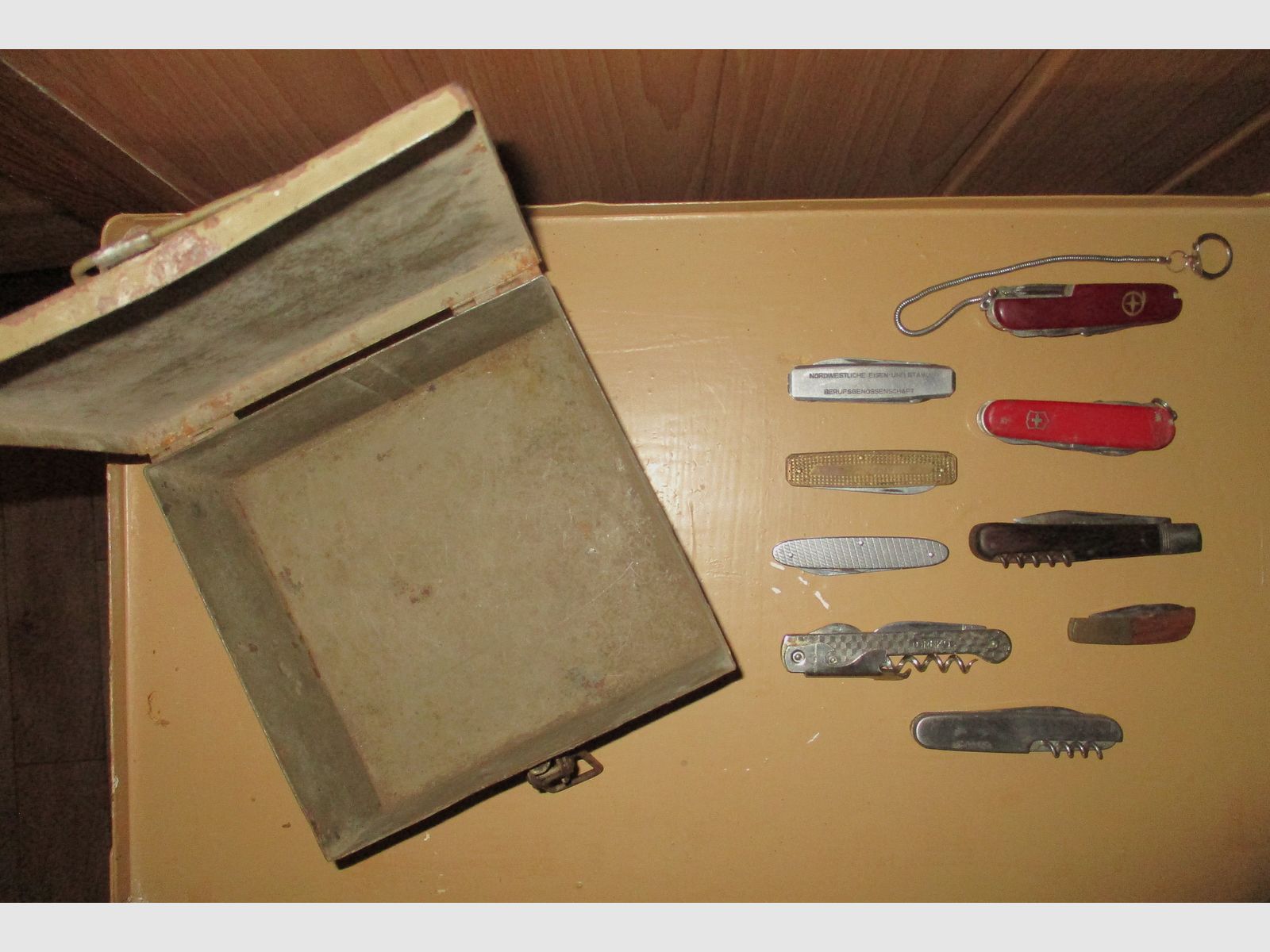 Swiss army knife, among other things, old metal ammunition box, medal on chain, among other things, military
