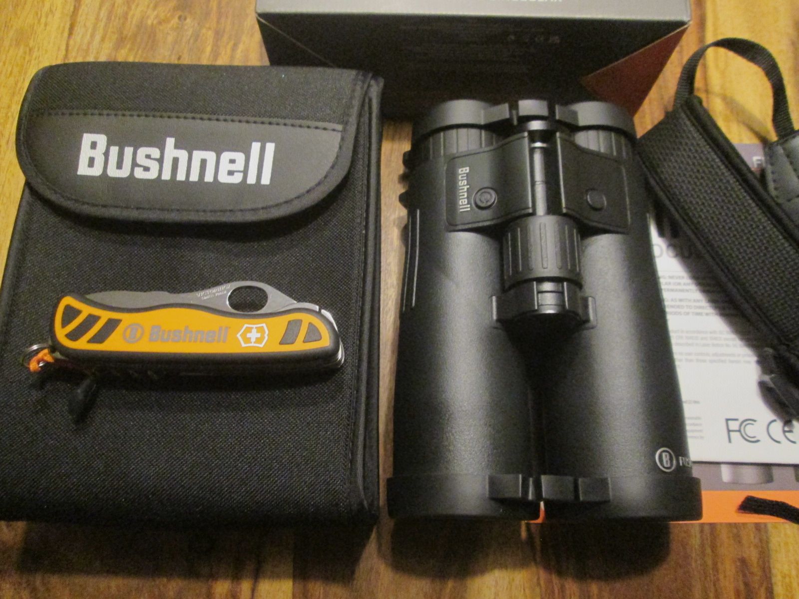 Bushnell binoculars 10x42 with rangefinder including Victorinox pocket knife NEW unused with warranty !!!