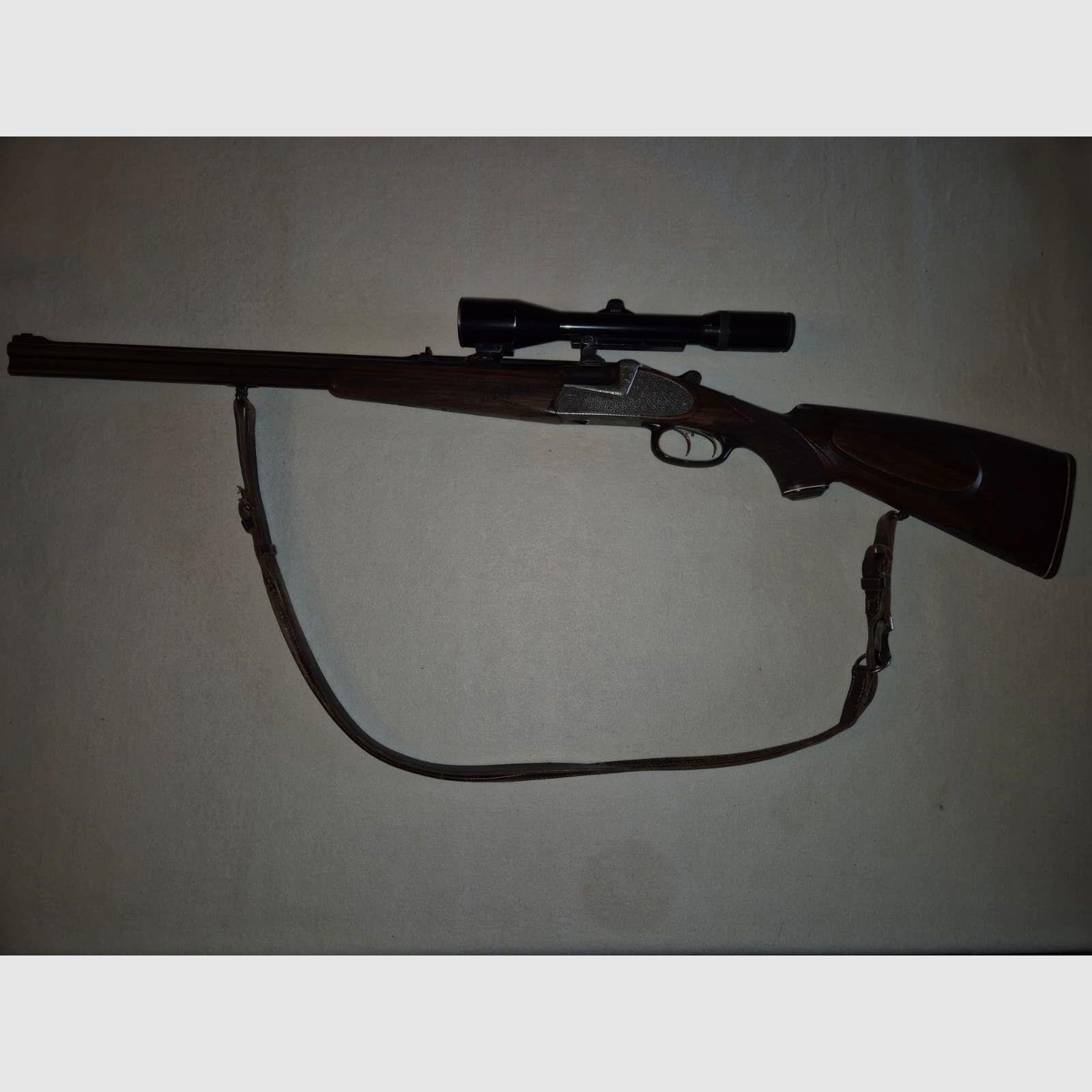 combination gun with two rifle barrels and one shotgun barrel