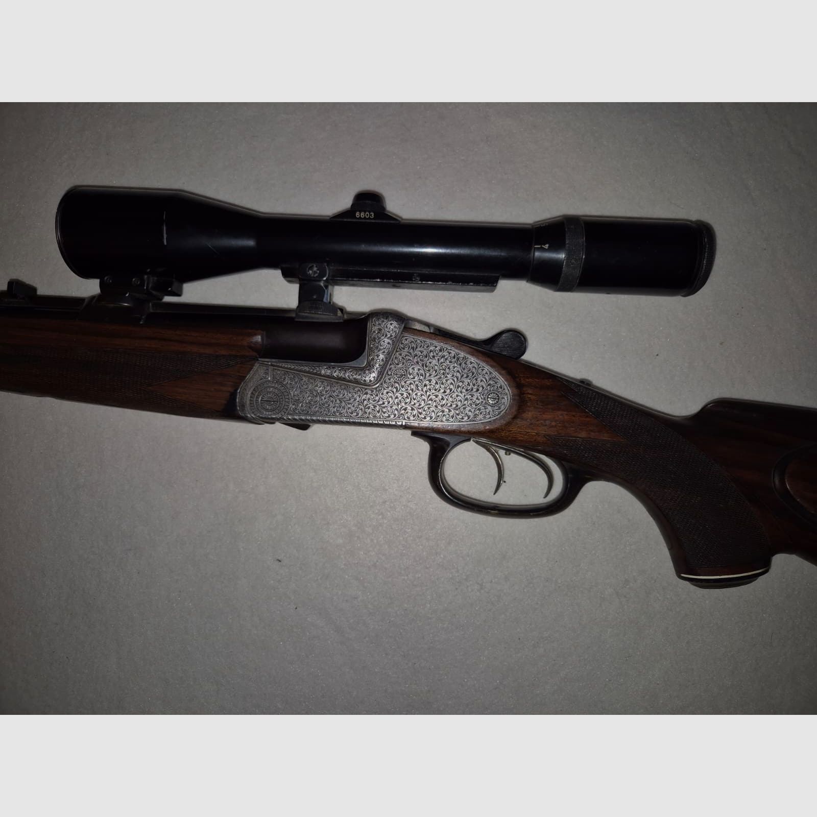 combination gun with two rifle barrels and one shotgun barrel