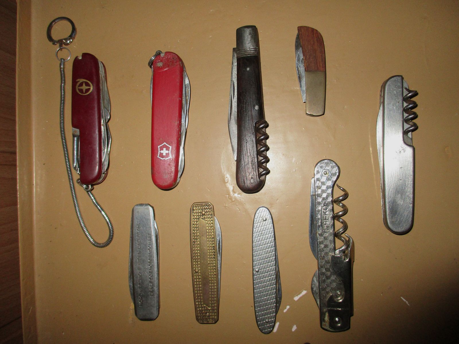 Swiss army knife, among other things, old metal ammunition box, medal on chain, among other things, military