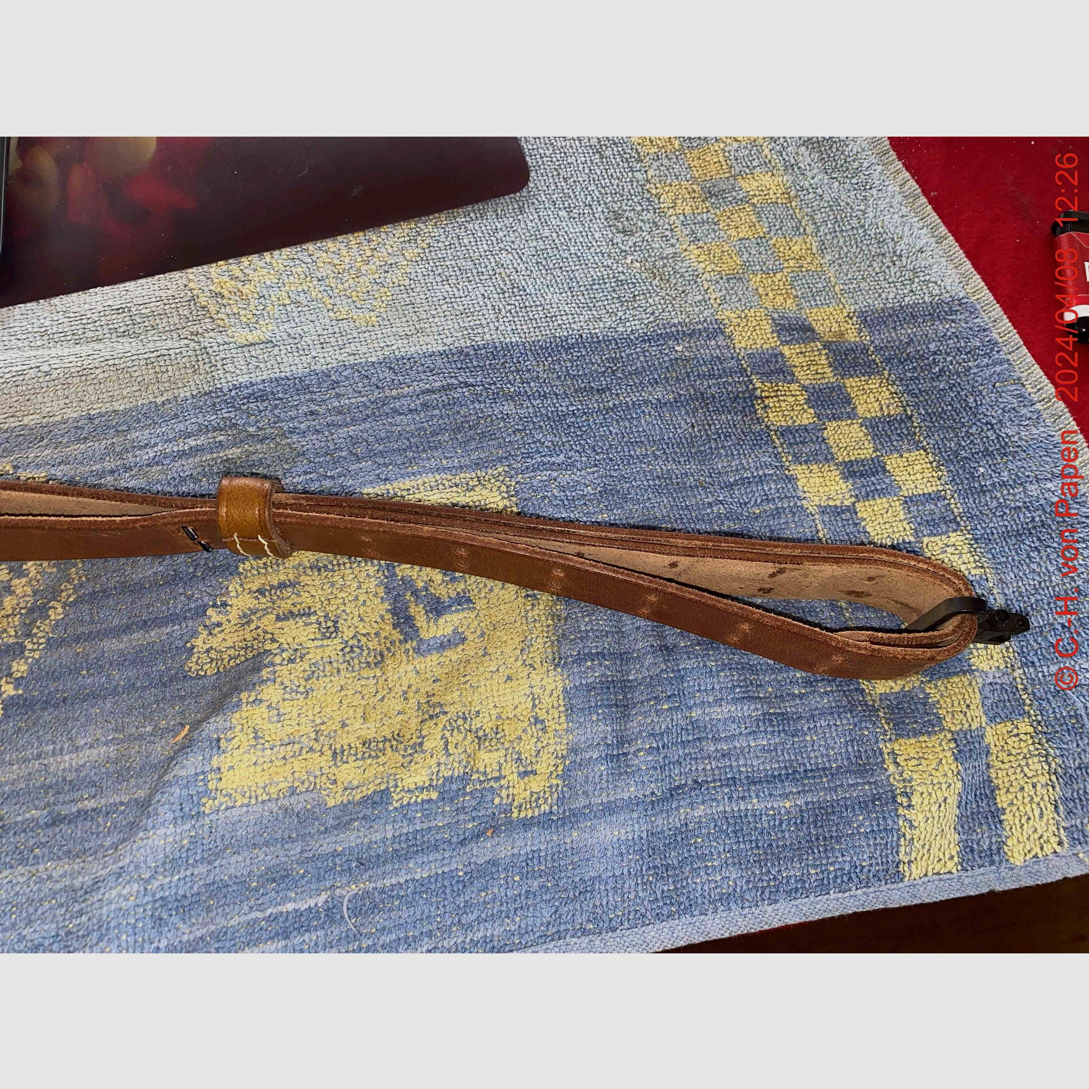 Rifle sling with strap buckle