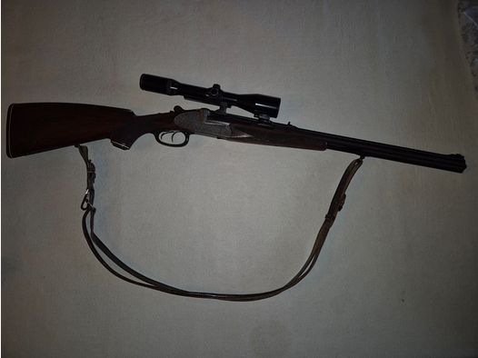 combination gun with two rifle barrels and one shotgun barrel