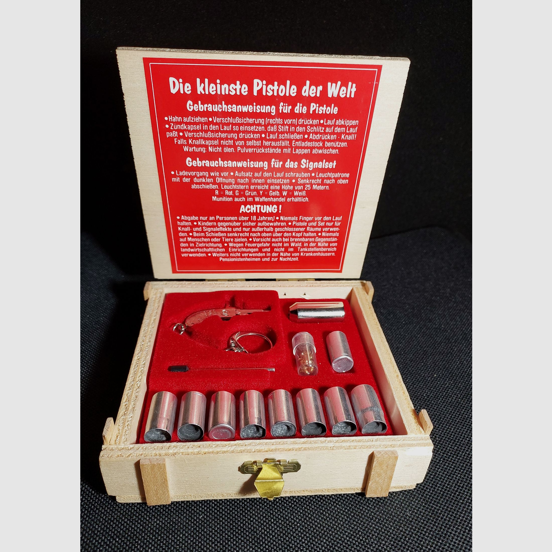 Original Berloque Mini Pistola niquelada incluyendo cápsulas de explosión y estrellas brillantes en caja de madera calibre 2 mm (P18)