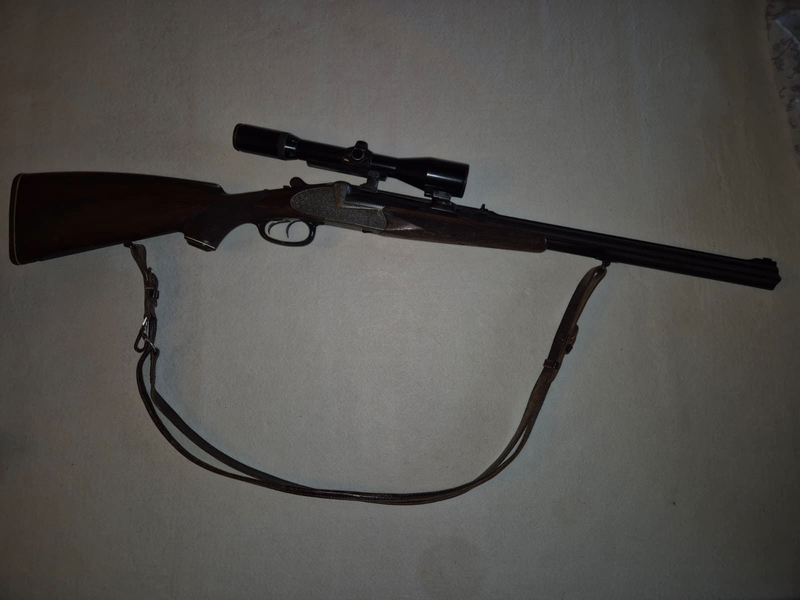 combination gun with two rifle barrels and one shotgun barrel