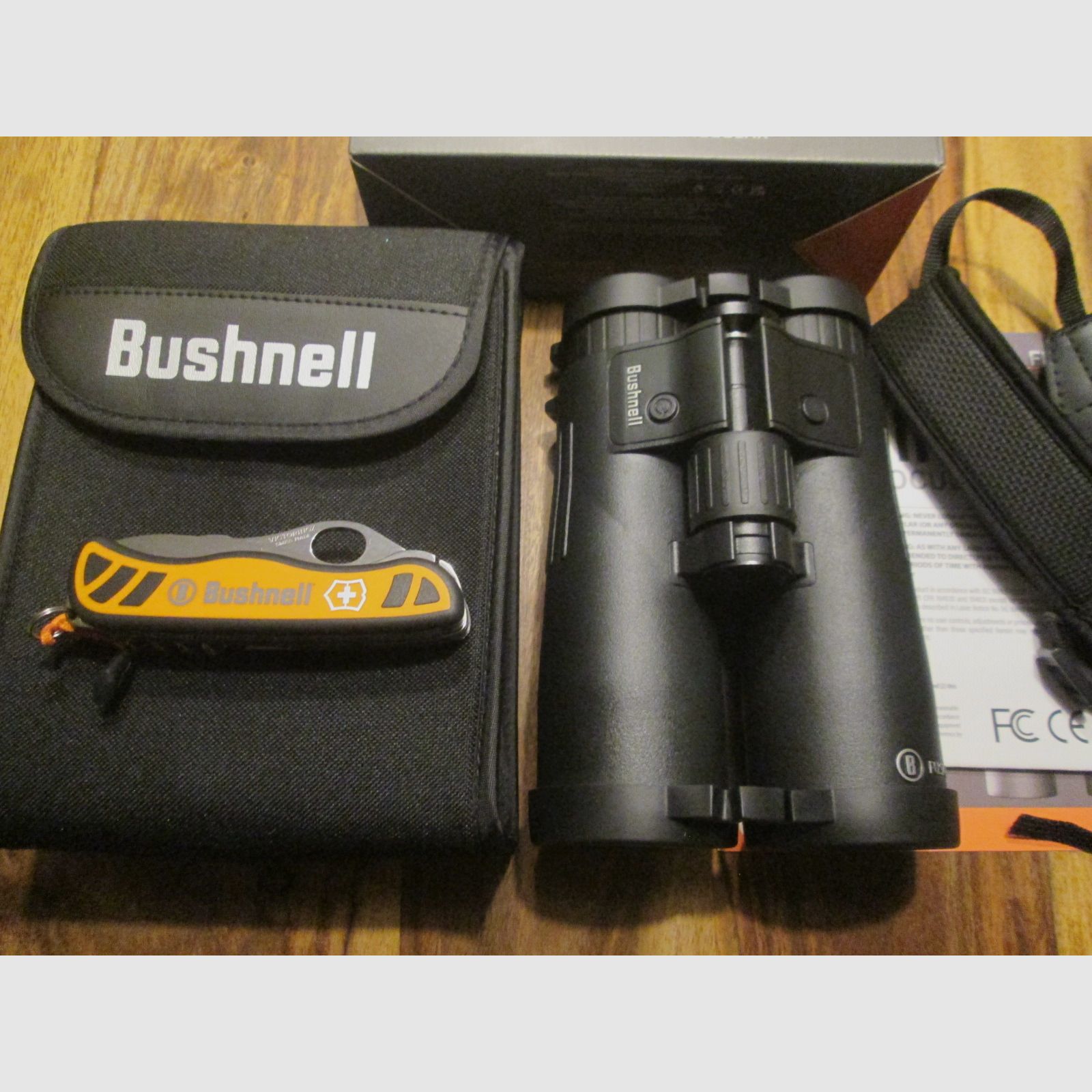 Bushnell binoculars 10x42 with rangefinder including Victorinox pocket knife NEW unused with warranty !!!