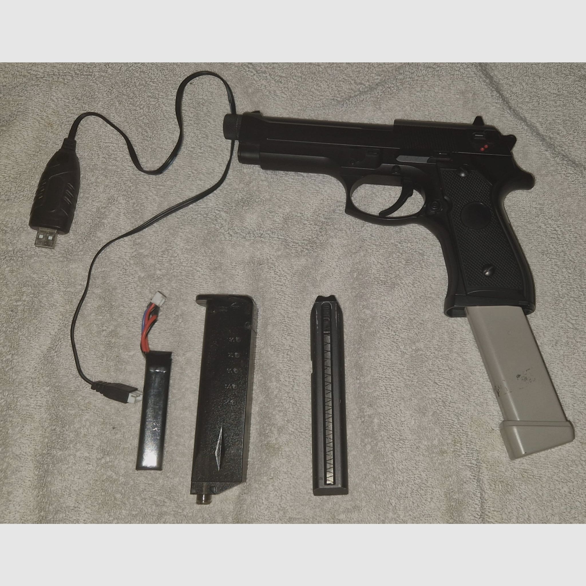 Cyma CM.126 (Mosfet and tracer thread) with an 80 BB mag in gray, charging cable, battery, and speedloader