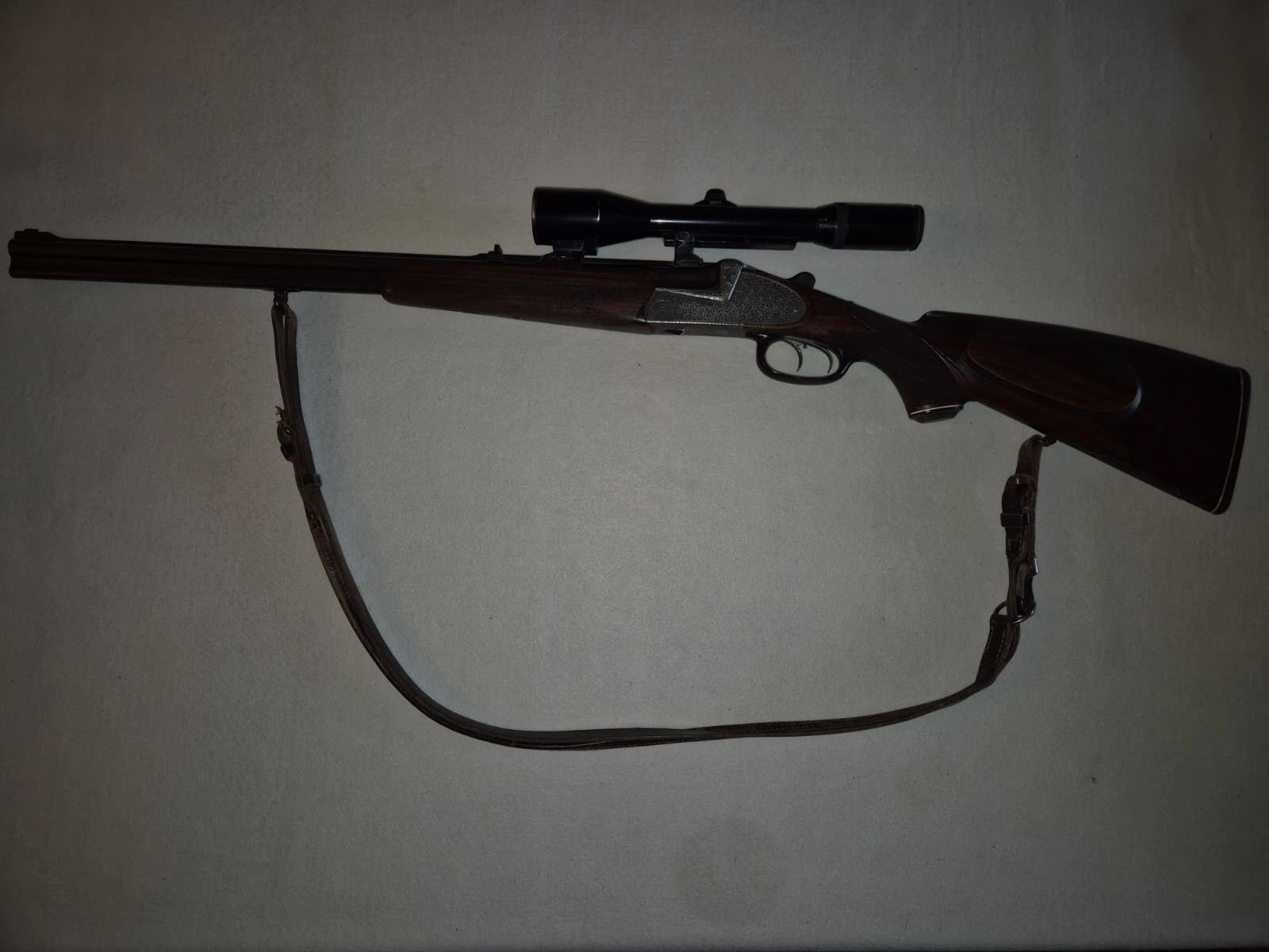combination gun with two rifle barrels and one shotgun barrel