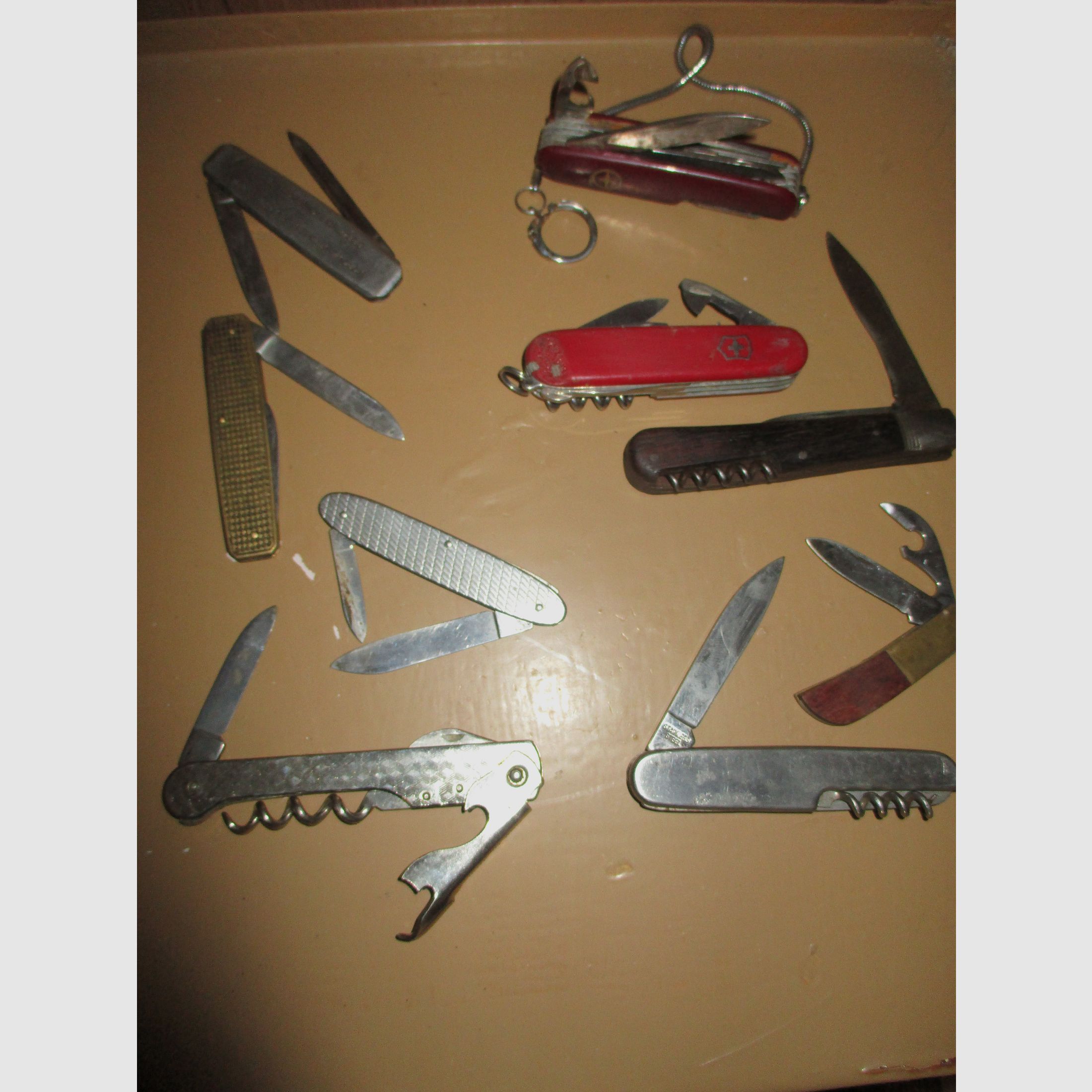 Swiss army knife, among other things, old metal ammunition box, medal on chain, among other things, military