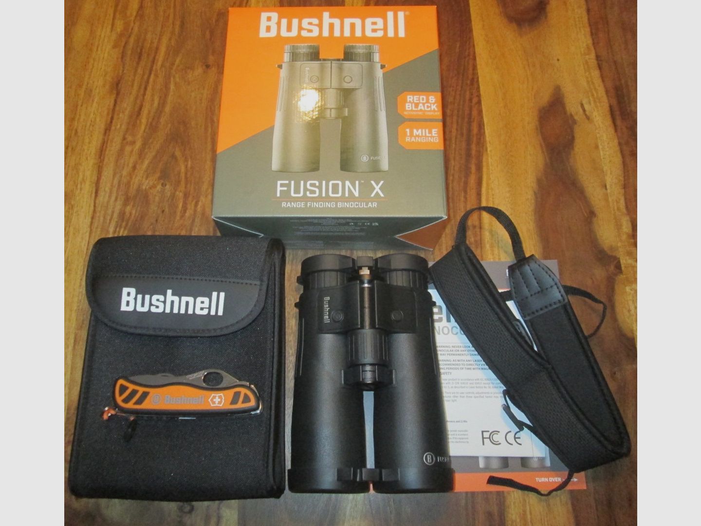 Bushnell binoculars 10x42 with rangefinder including Victorinox pocket knife NEW unused with warranty !!!