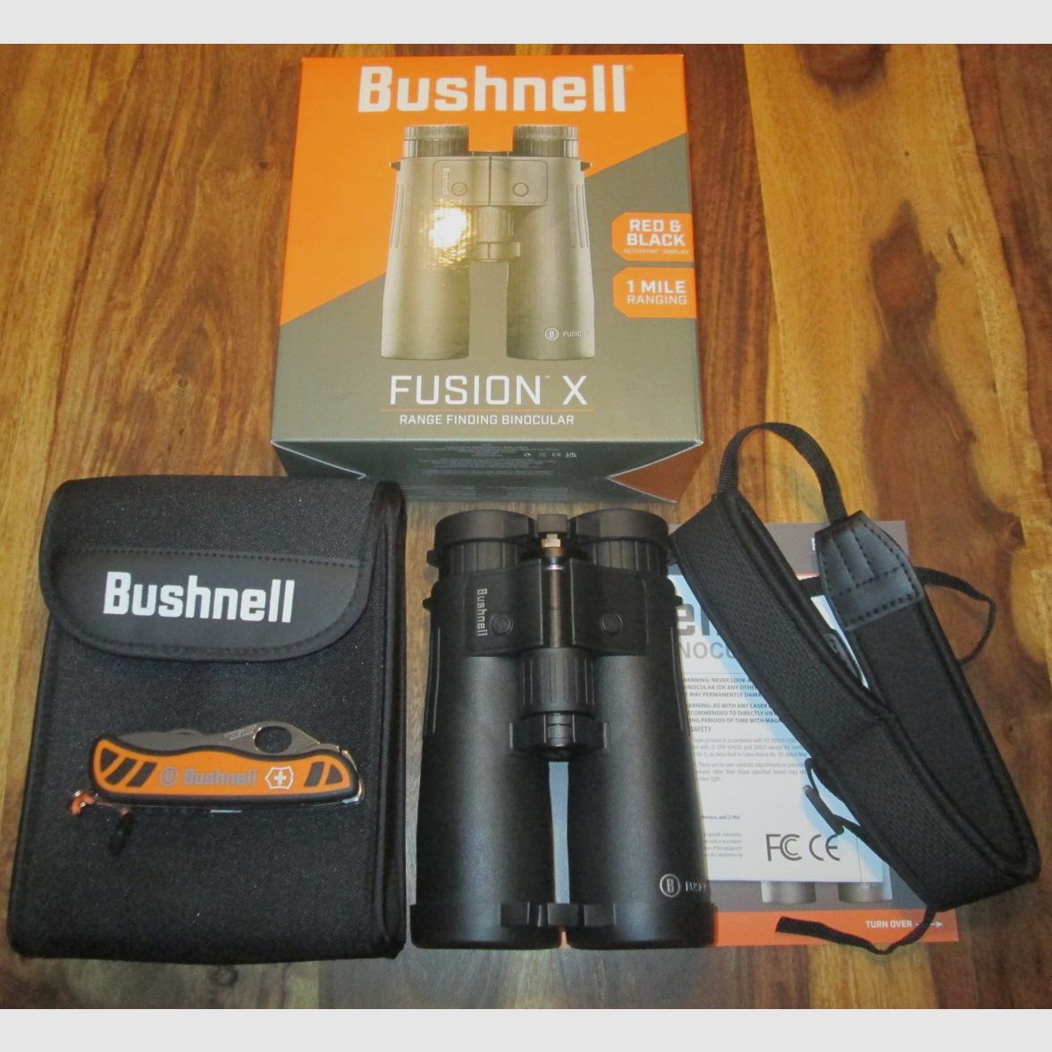 Bushnell binoculars 10x42 with rangefinder including Victorinox pocket knife NEW unused with warranty !!!