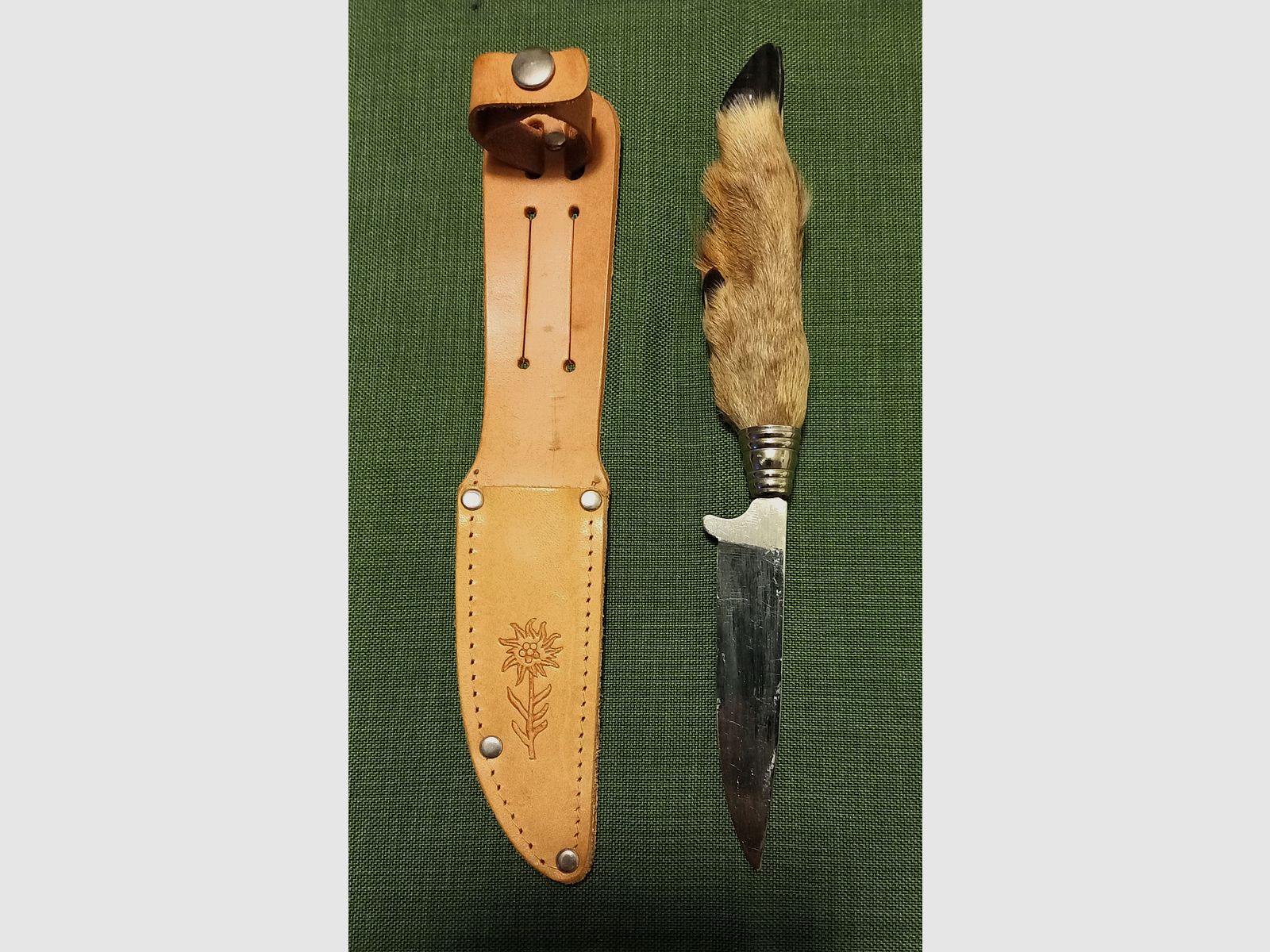 Traditional hunting knife with deer foot handle