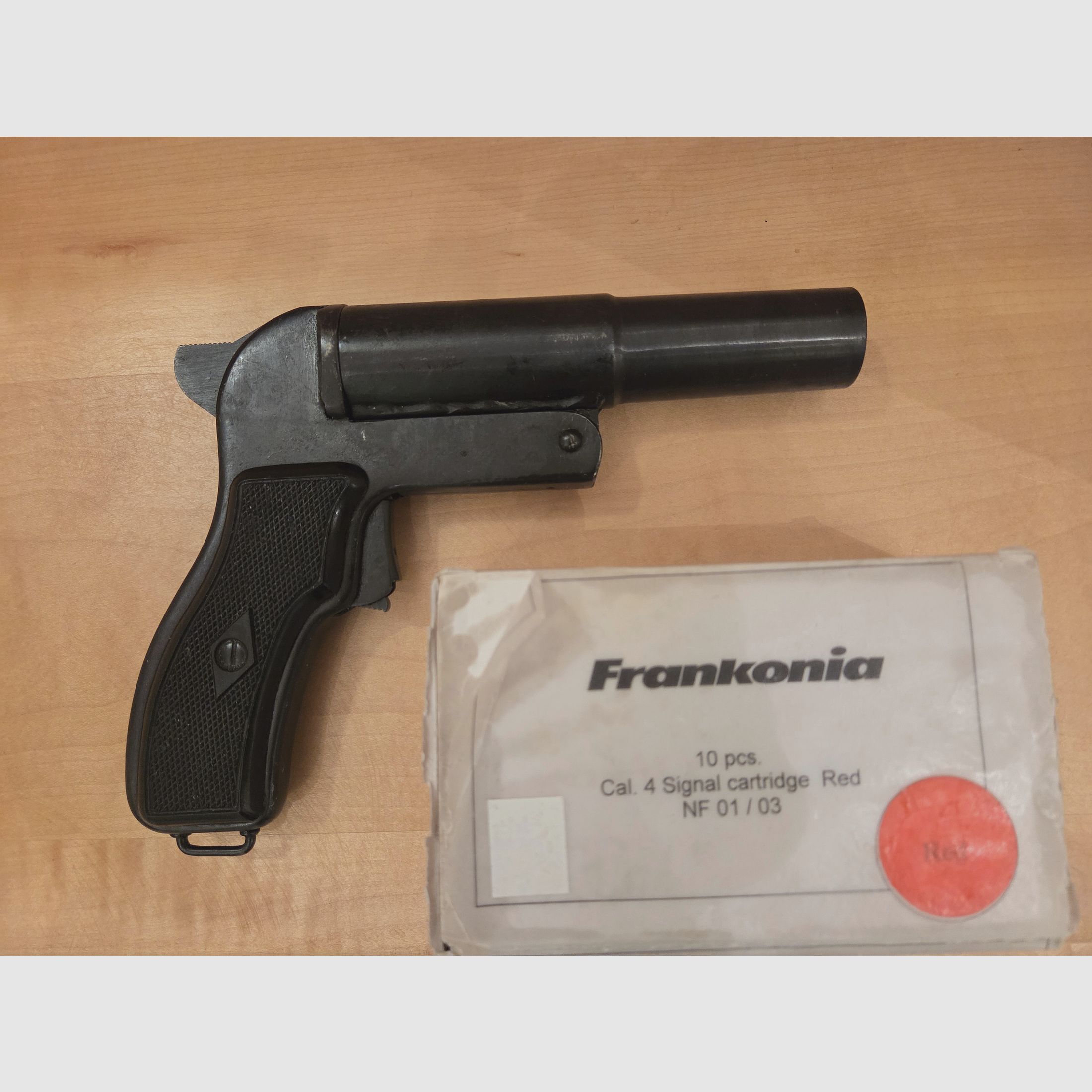 Flare gun with red signal ammunition