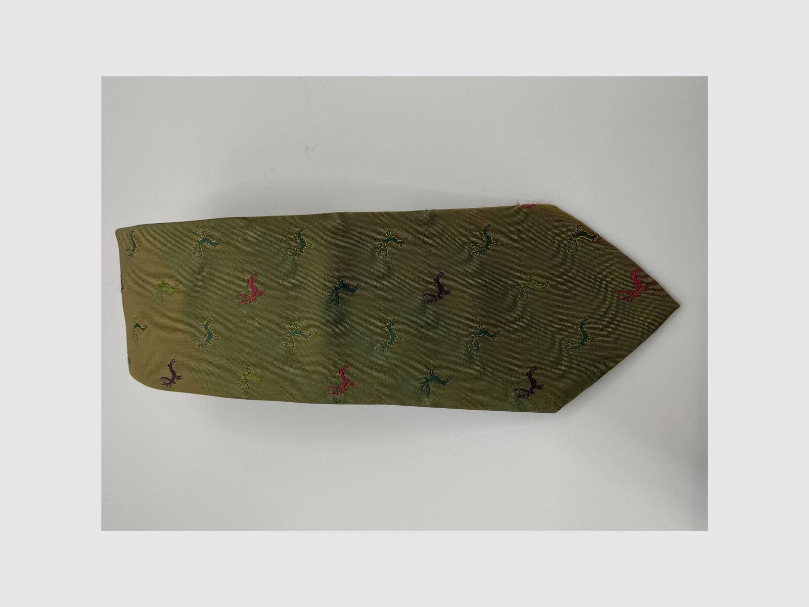 Tie dark green with a bit of orange motif dark green, light green, pink, and purple deer